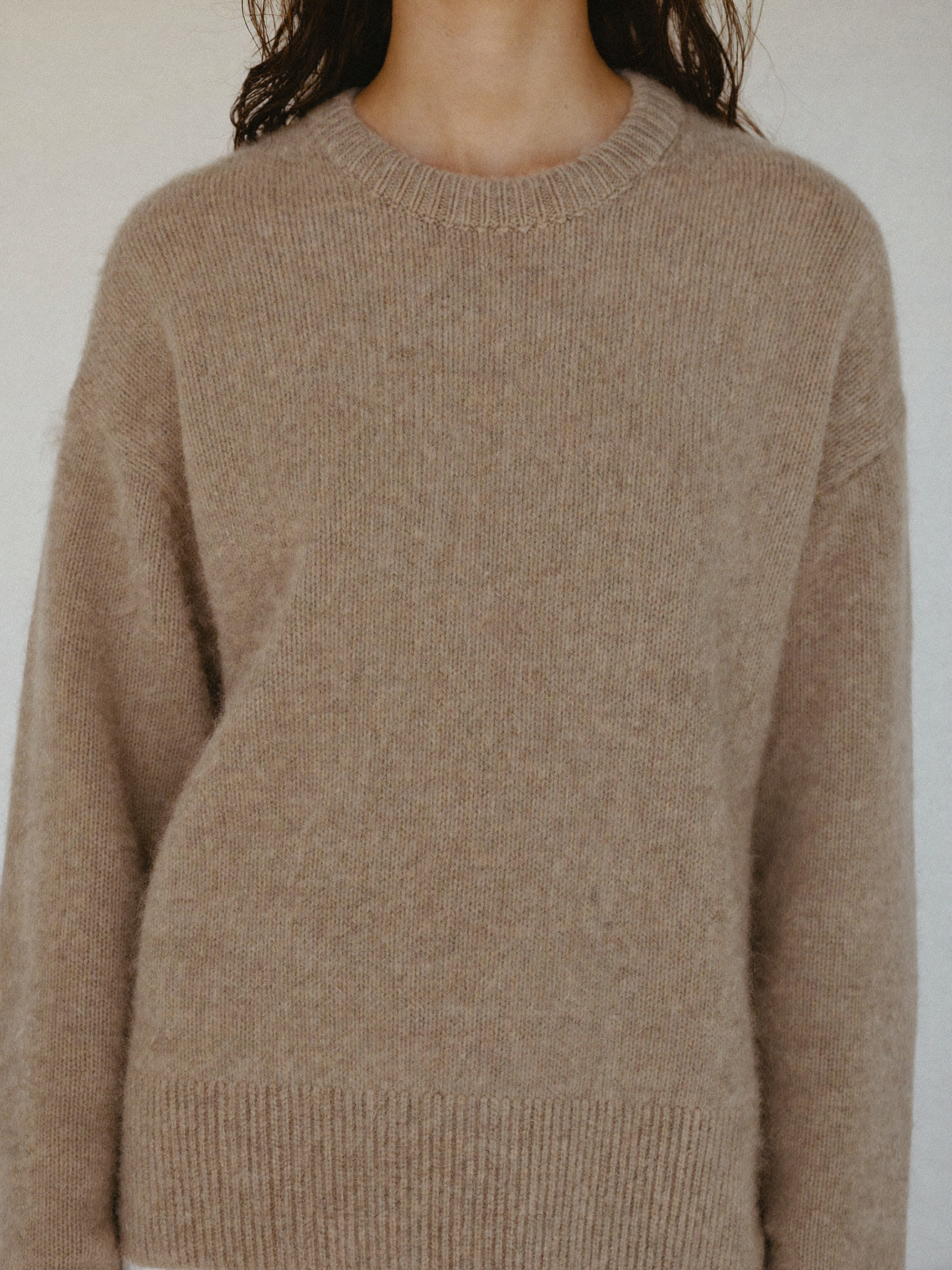 Women's merino crew-neck knit in oatmeal, worn